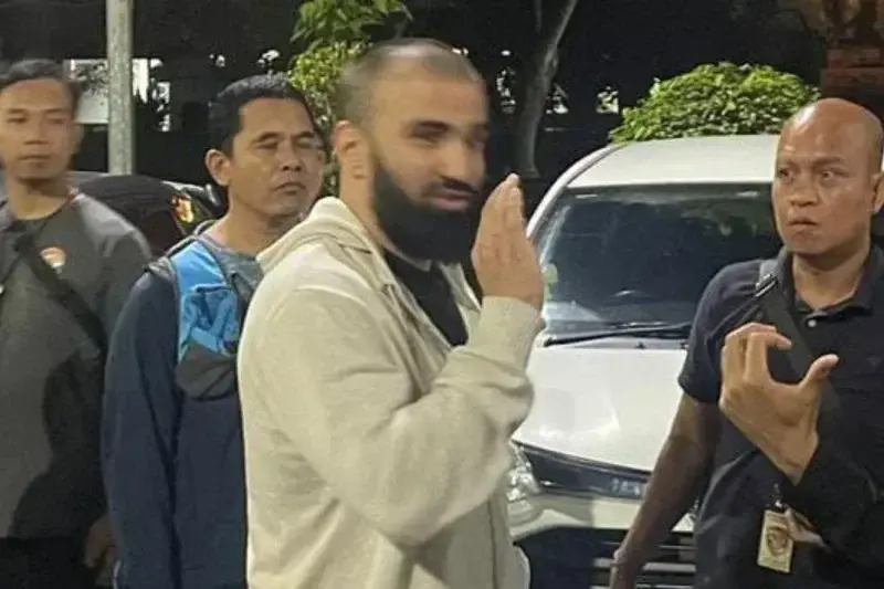 Polisi menggiring terduga pelaku perampokan berinisial KA saat ditangkap di Bandara Internasional I Gusti Ngurah Rai, Bali. ANTARA/HO-Istimewa